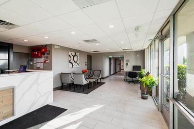 Lobby lounge area with front desk & seating area at Garden Executive Hotel, one of the best hotels in South Plainfield, NJ