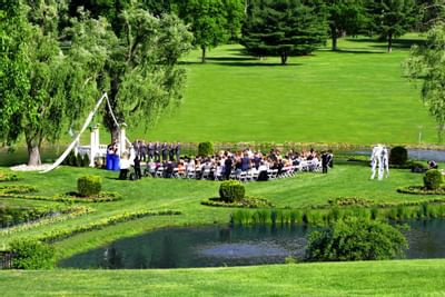 Outdoor wedding ceremony by the lake at Honor’s Haven Retreat