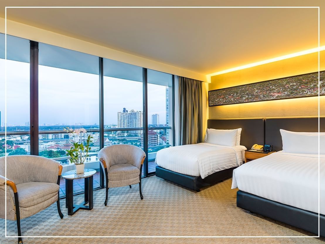 Twin beds & furniture in Suite at Chatrium Residence Sathon