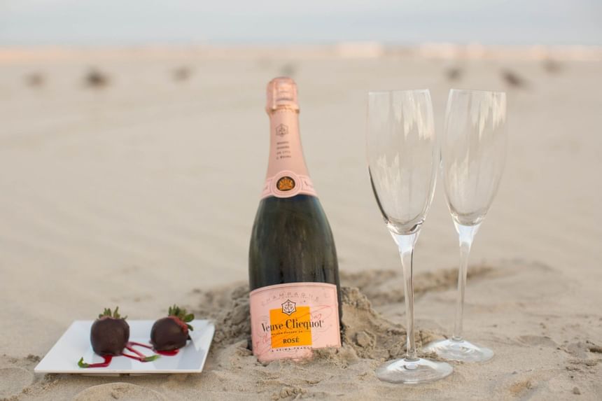 Chilled champagne and wine glasses on beach near ICONA Diamond