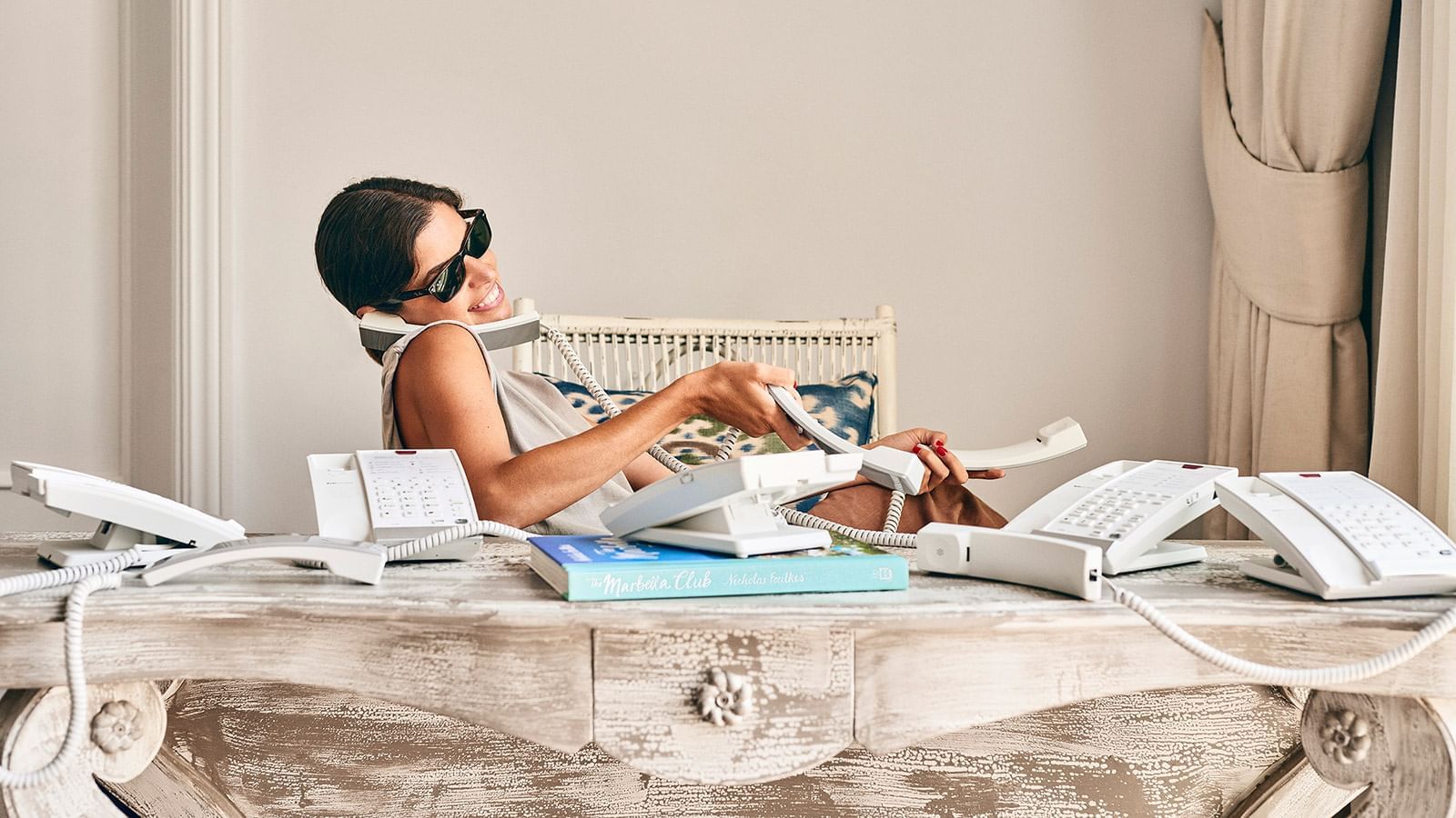 A woman busy with answering calls at Marbella Club