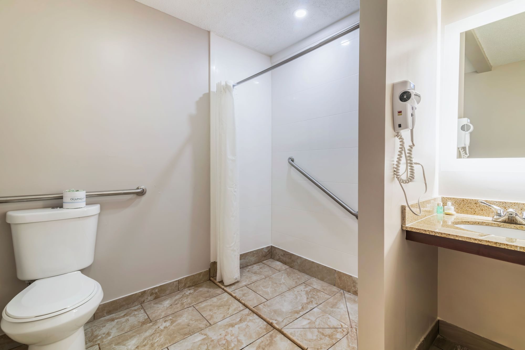 a bathroom with a toilet, shower, and sink