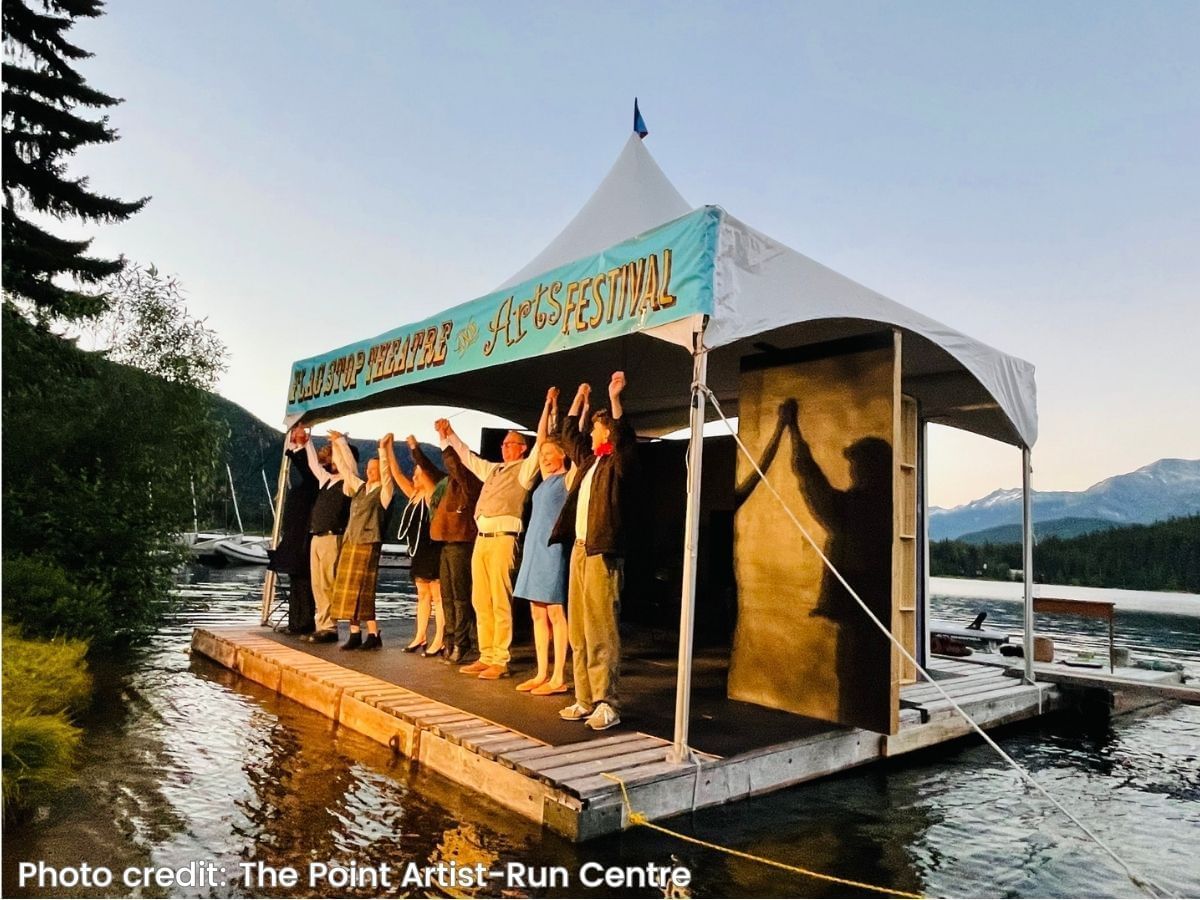 People in The Flat Stop Festival on the deck by the lake near Blackcomb Springs Suites