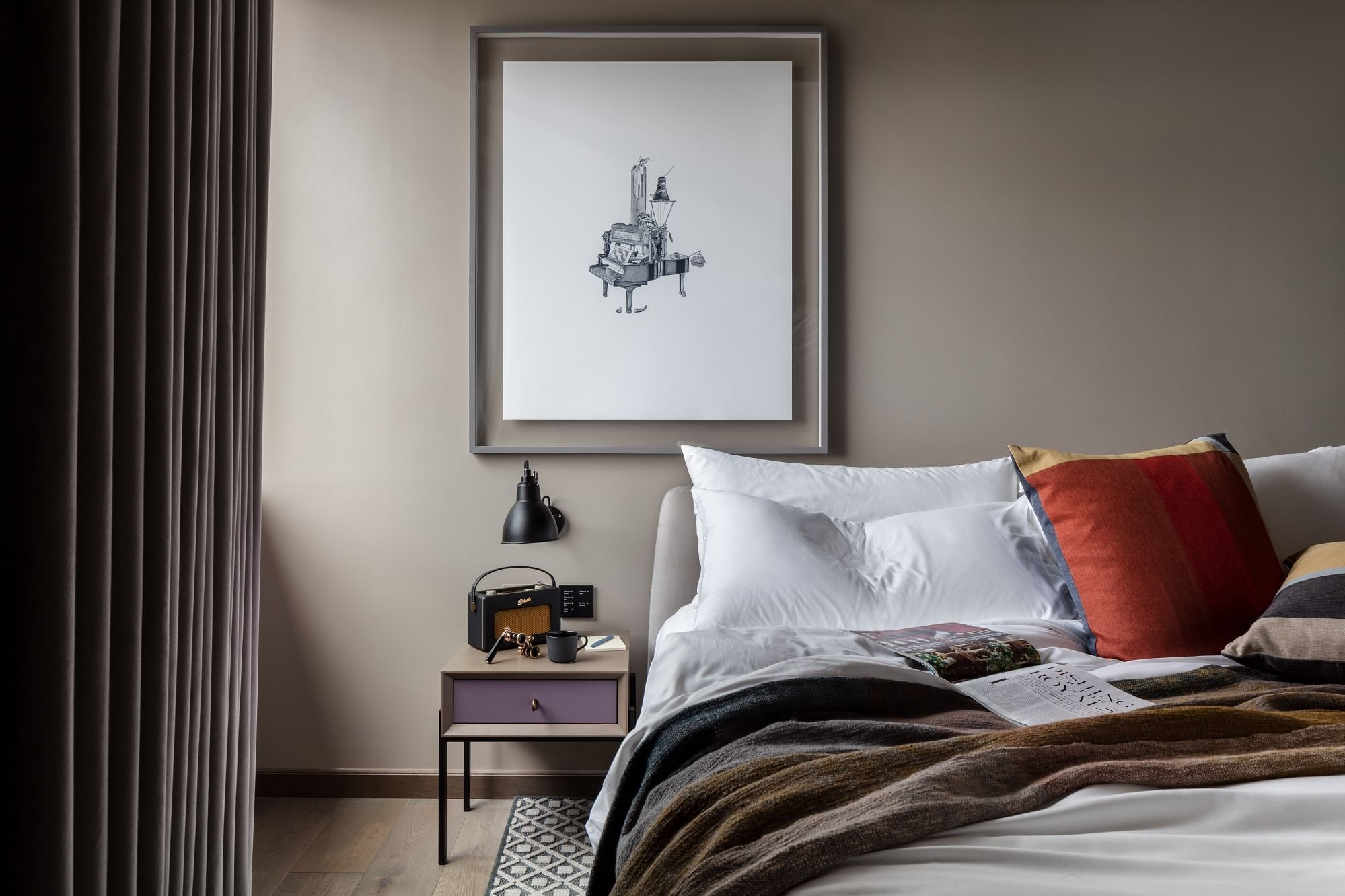 Double bed with a side table and wall art in a room at The Londoner
