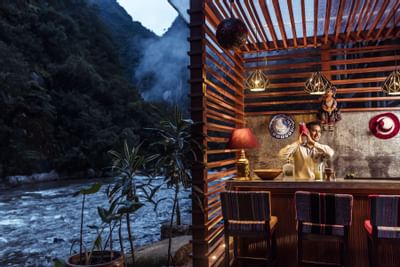 bartender making cocktail in outdoor terrce