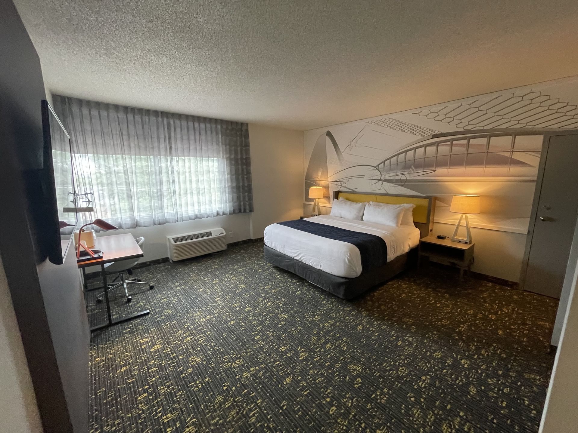 King bed, TV & workspace in Single King Handicap Accessible at St. Louis Airport Hotel