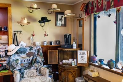 Cozy corner with western hats on display and a coffee station at The Ranch at Ucross