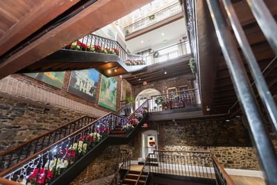Staircase featuring floral arrangements & decorations at River Street Inn