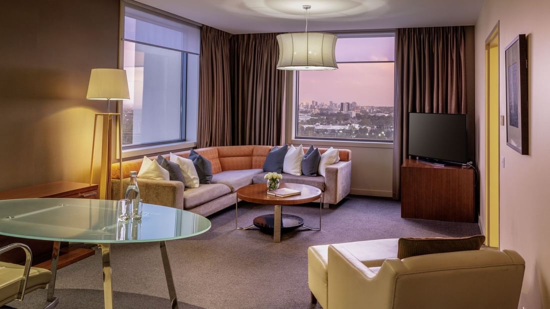 TV lounge by the window and carpet floors in Pullman Suite Lounge Room at Pullman Sydney Olympic Park