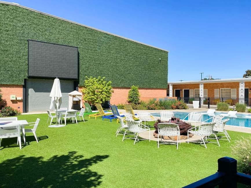 Courtyard setting featuring lawn chairs and a pool at The Fredonia Hotel