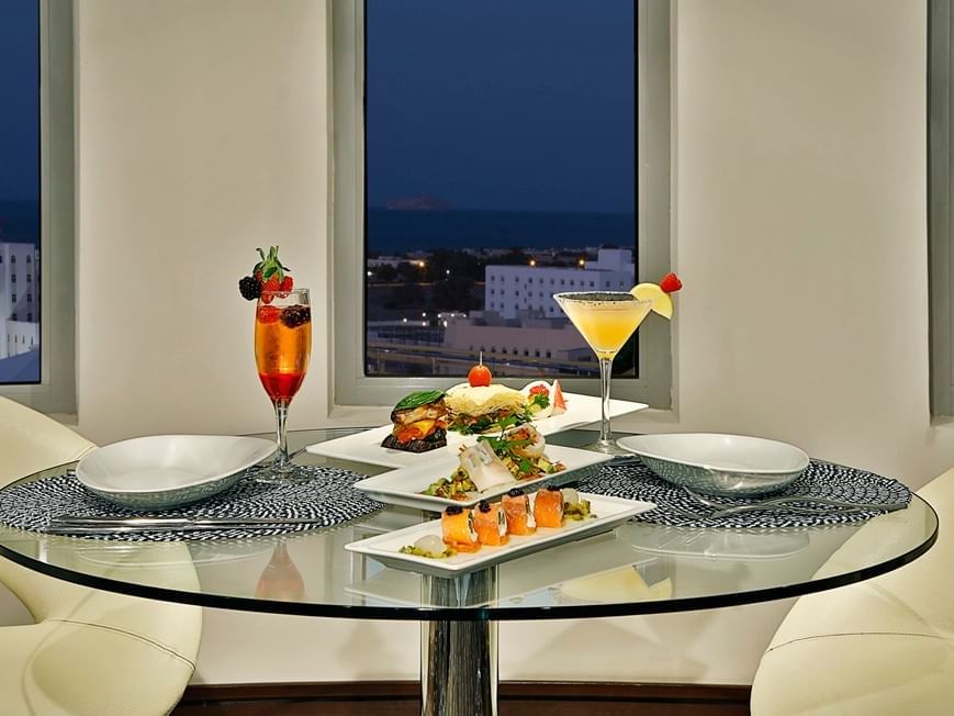 Dining table by city view in Sky Lounge at City Seasons Muscat