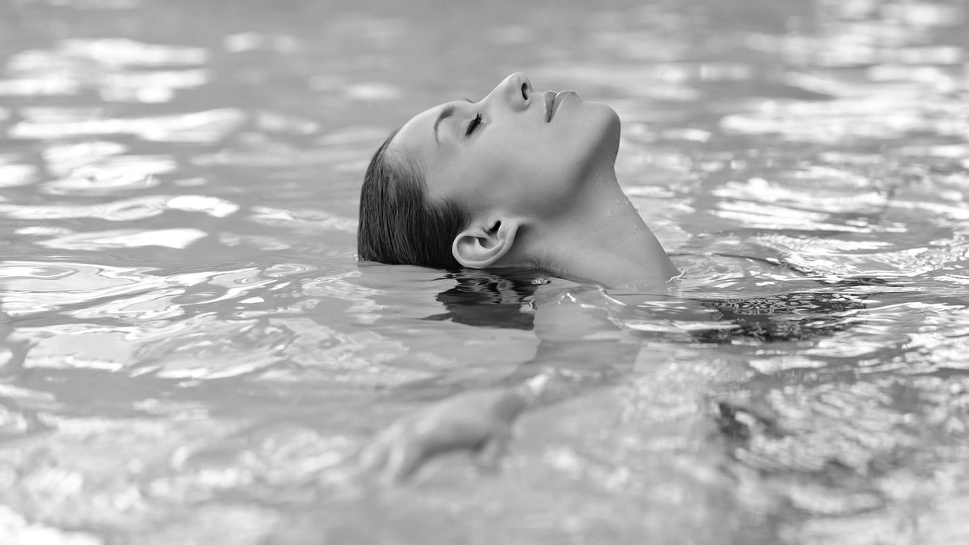 A lady is relaxing in the pool at Crown Hotels