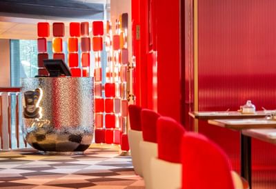 Modern interior of George's Restaurant at Hotel Éclat Beijing with bold red accents and unique decor.