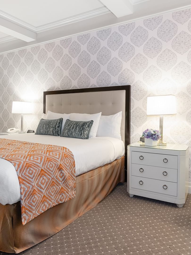 Elegant Premier Room with a bed between the side tables at Warwick New York