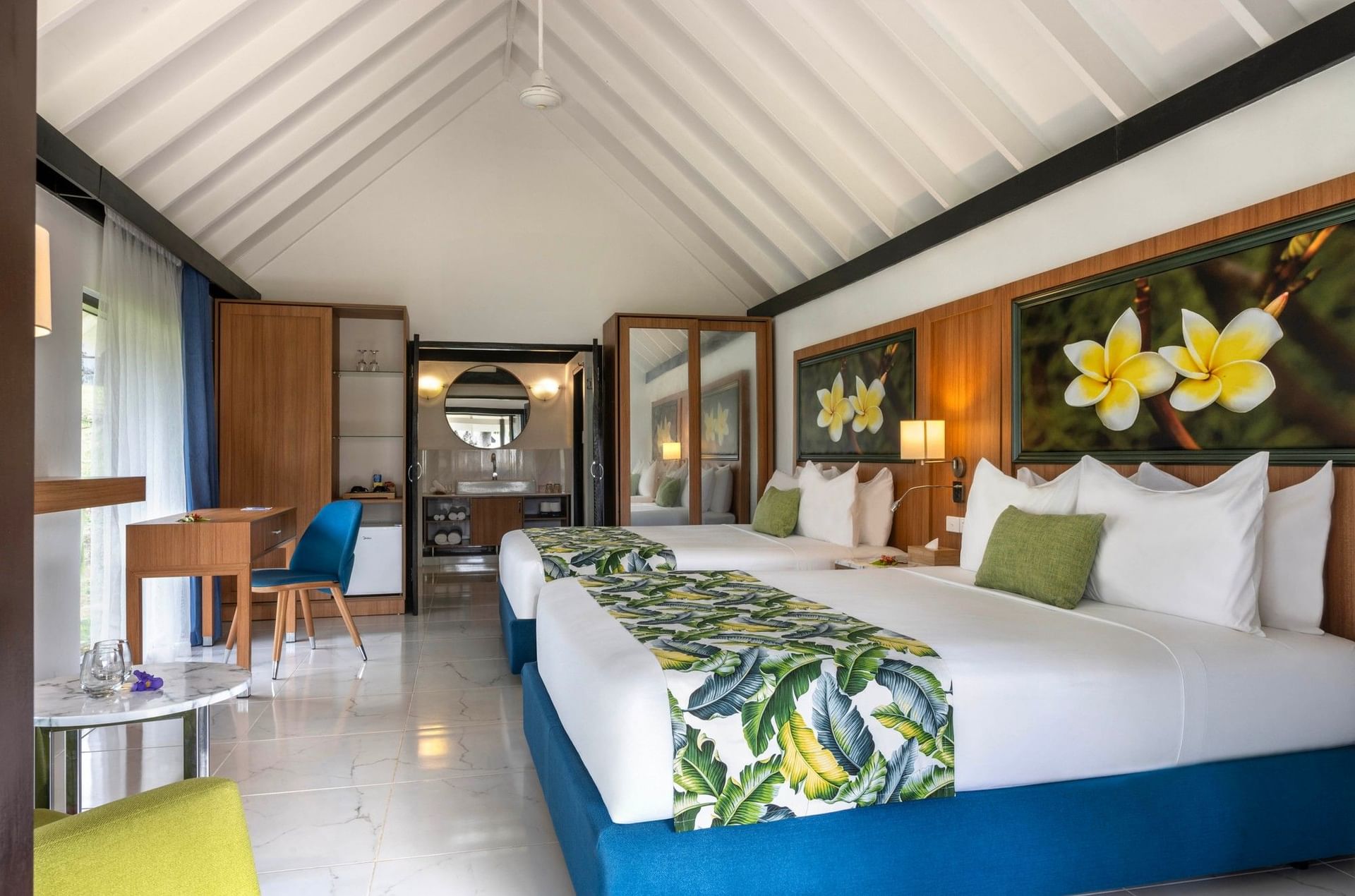 Twin bed facing table & chair with plumeria floral artwork in Garden Bungalow at warwick le lagon-vanuatu