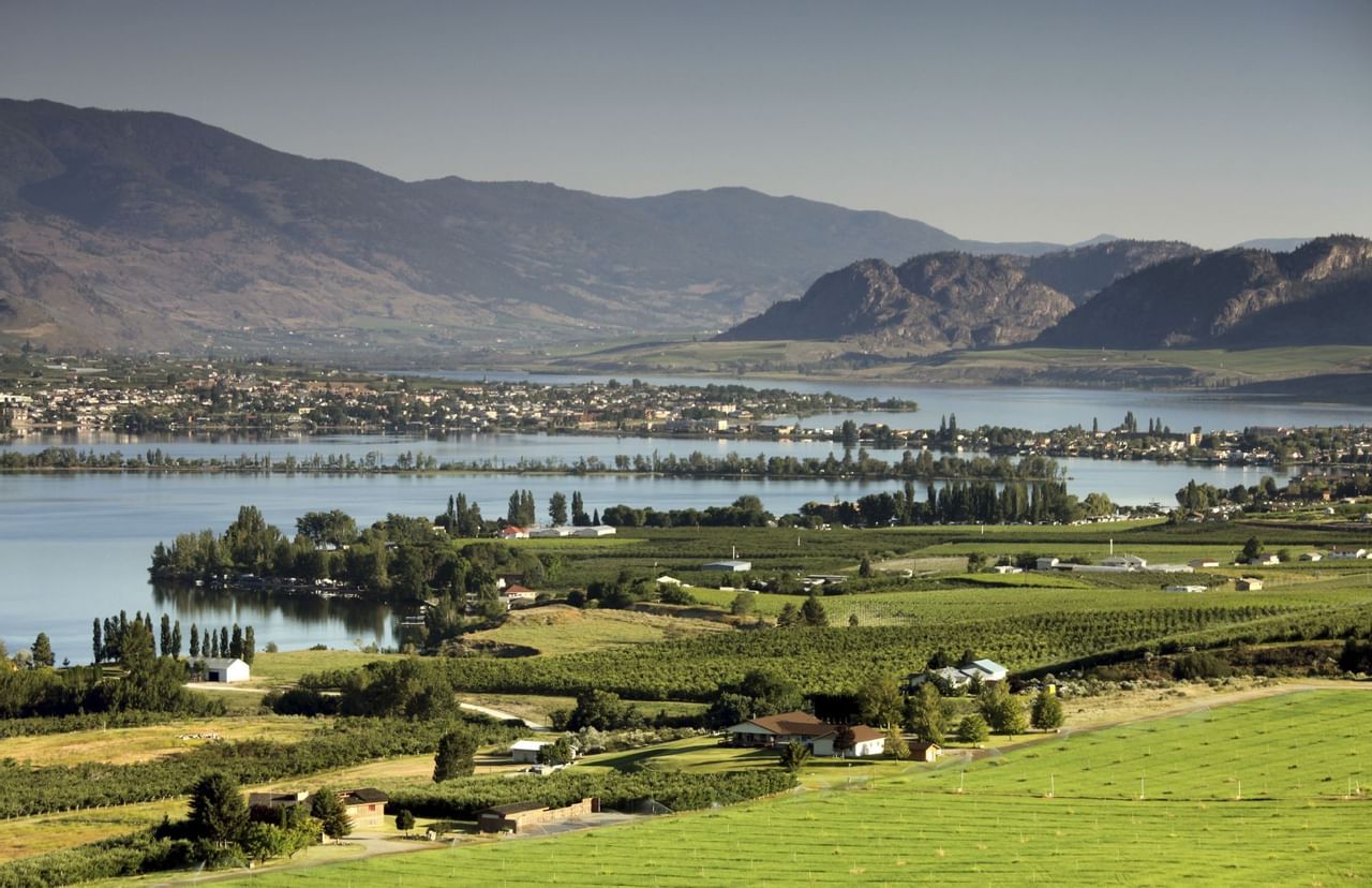 Vast farmland with town, ocean and mountains in background