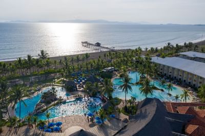 Aerial view of outdoor pool with ocean view from Fiesta Resort