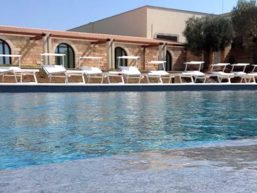 Poolbeds by the outdoor pool at 
Hotel Masseria Stali