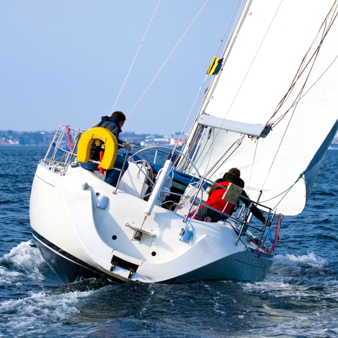 Sailboat on the water with two people on board near Villa Premiere Boutique Hotel & Romantic Getaway