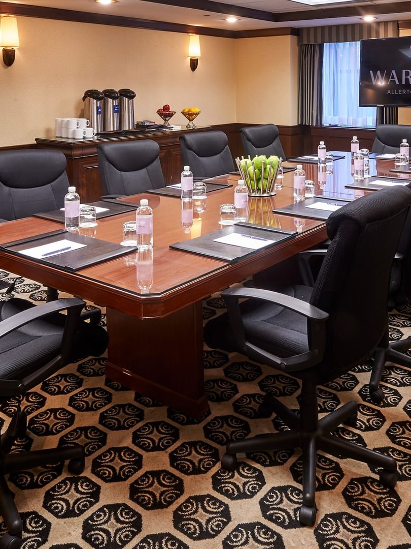 Boardroom setup facing TV in the Ogden Boardroom at Warwick Allerton Chicago