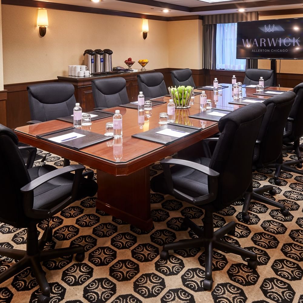 Boardroom setup facing TV in the Ogden Boardroom at Warwick Allerton Chicago