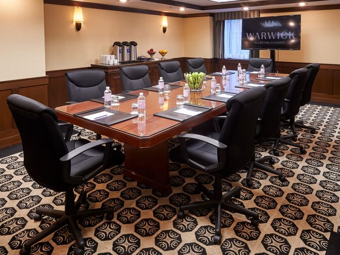 Boardroom setup facing TV in the Ogden Boardroom at Warwick Allerton Chicago
