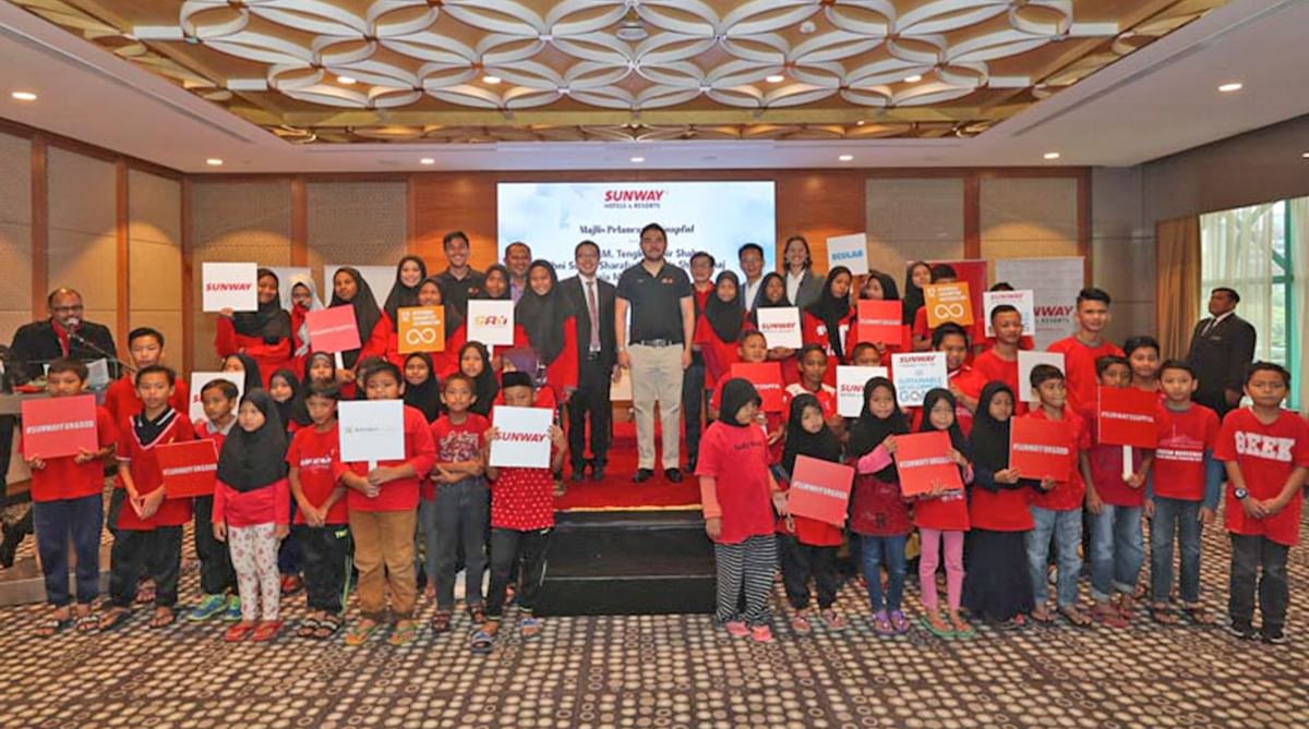 Group of kids posing at a food donation program, Sunway Lagoon