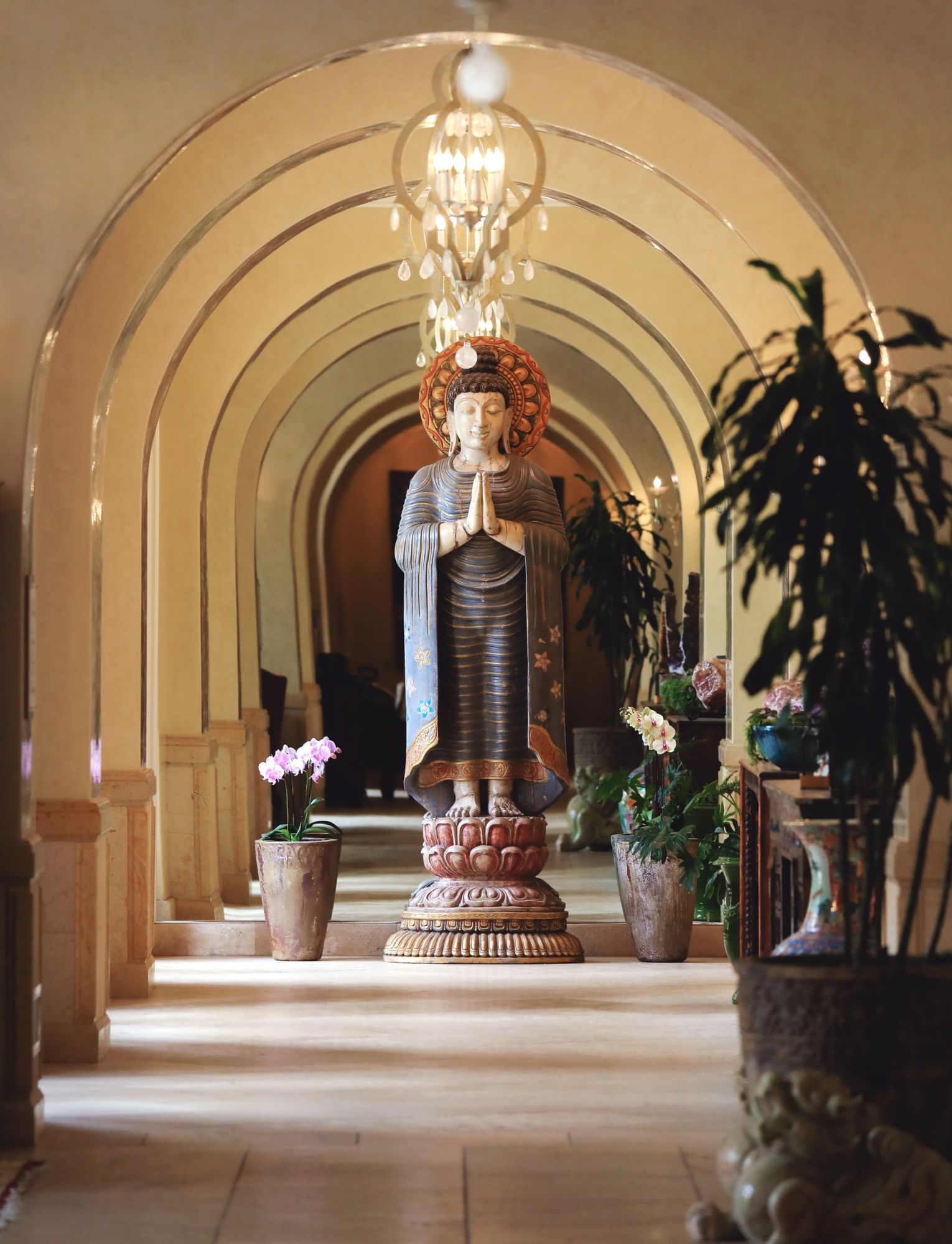 Arched hallway with statue at the end