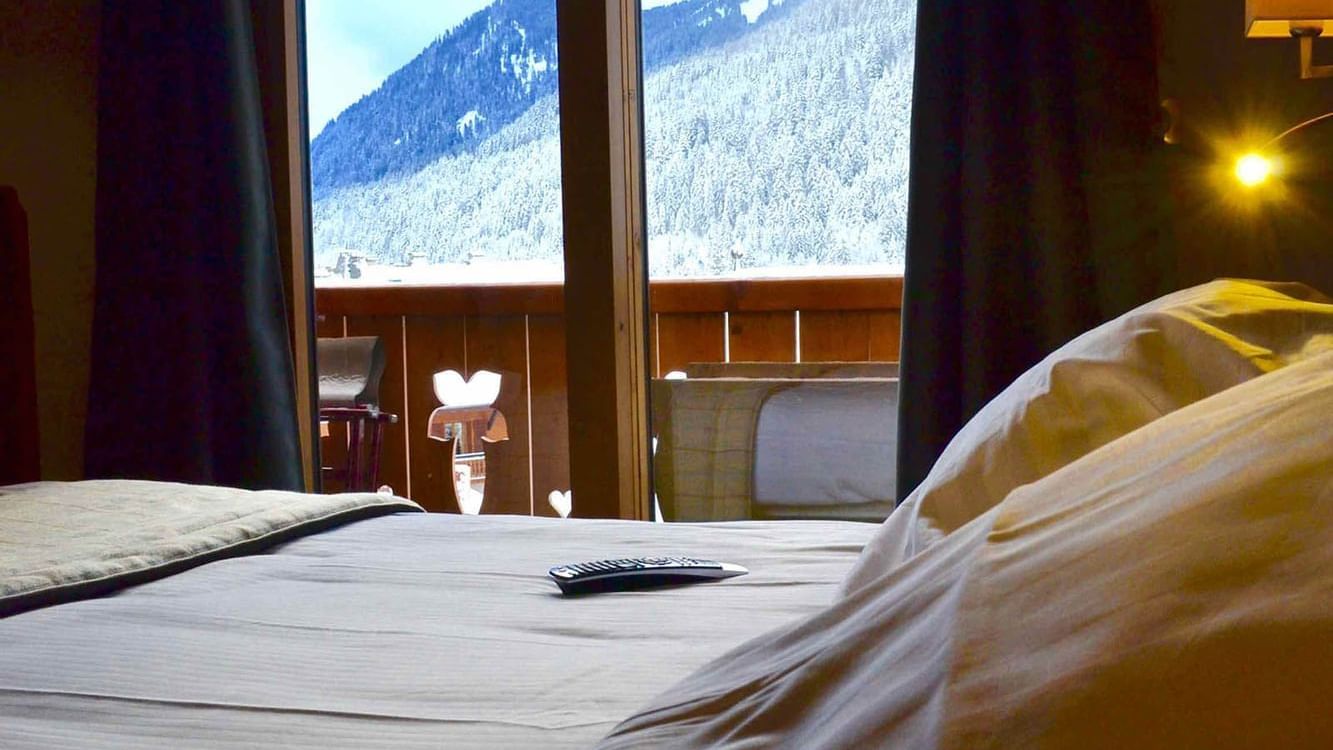 Cocoon Room bedroom with mountain views at The Originals Hotels