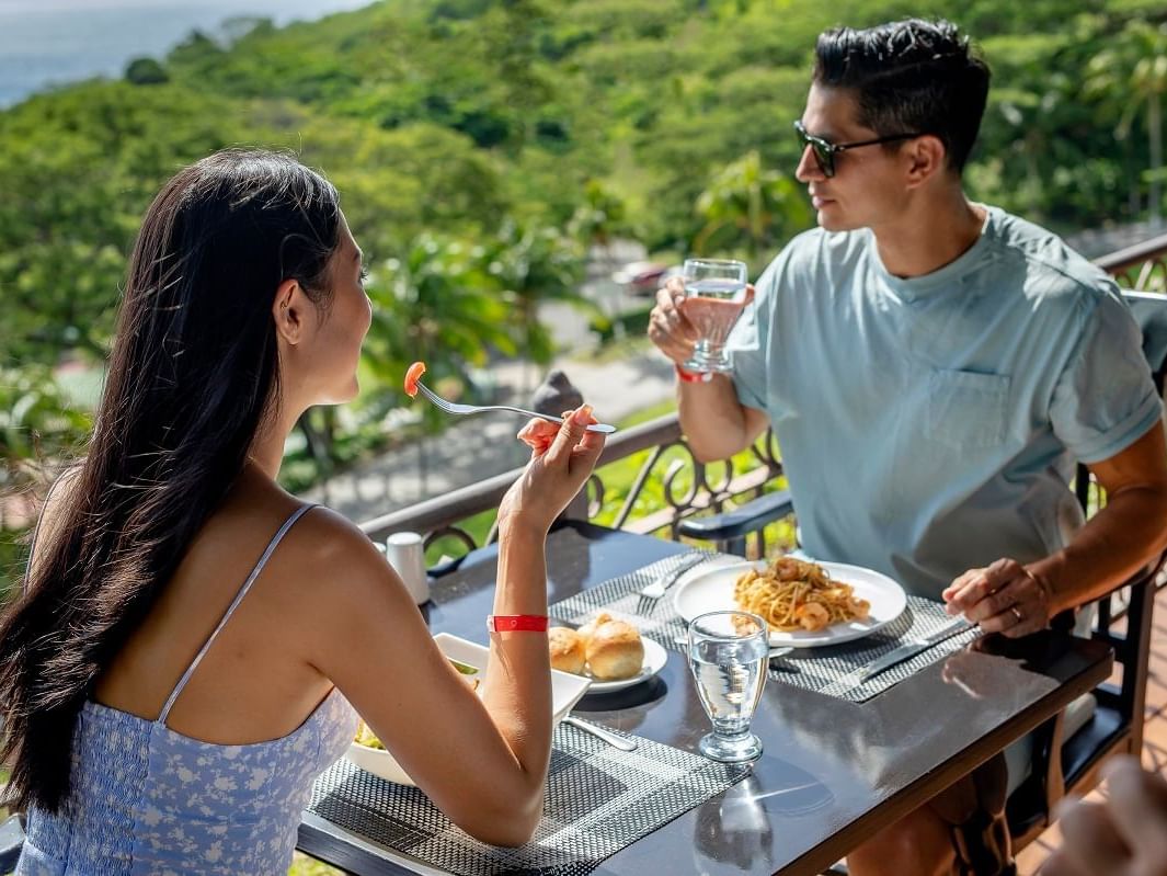 A couple enjoying their food in Bahia Restaurant at Villas Sol Beach Resort