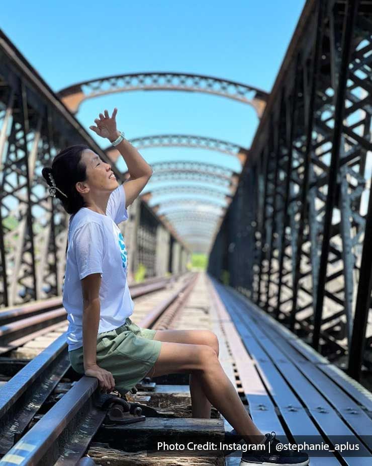 A woman sat on the Ipoh Victoria Bridge striking a pose - Lexis Suites Penang 