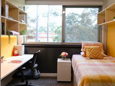 Cozy student room with desk and bed at La Trobe University – Menzies College.