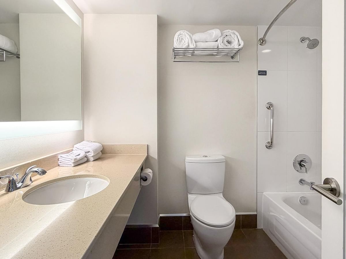 Clean modern bathroom with bathtub and sink at Coast Bastion Hotel in Nanaimo.