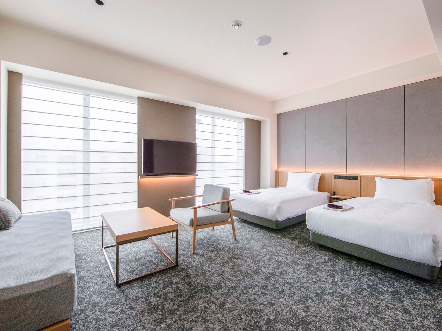 2 Cozy beds and lounge area in Oike Suite at Park Hotel Kyoto