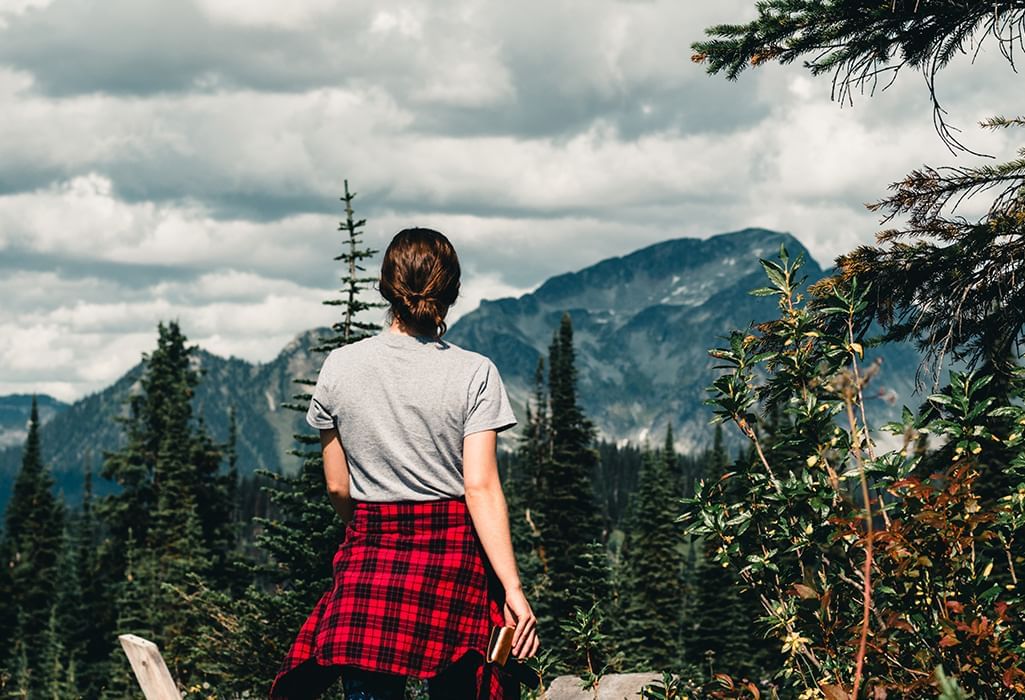 female hiker in front of large mountains