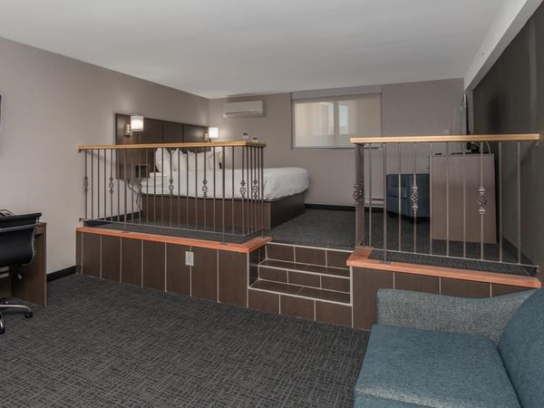 Room with a king-sized bed, sofa bed, and desk.