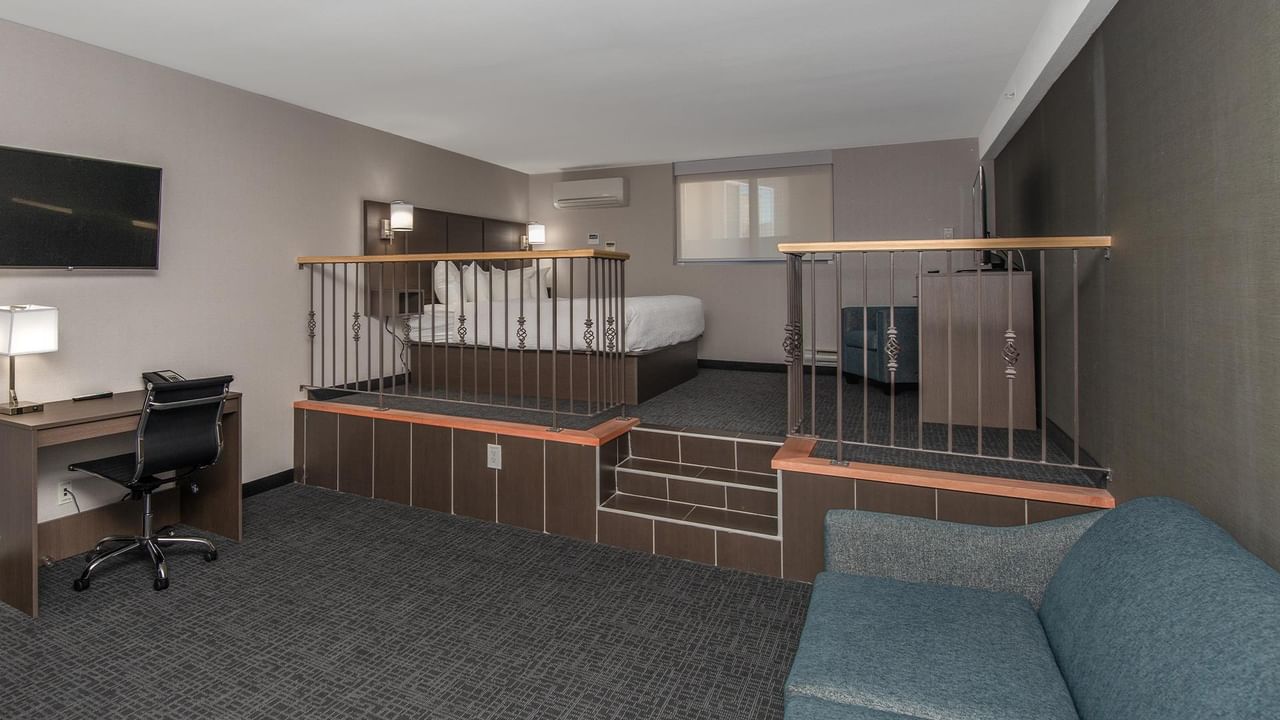 Room with a king-sized bed, sofa bed, and desk.