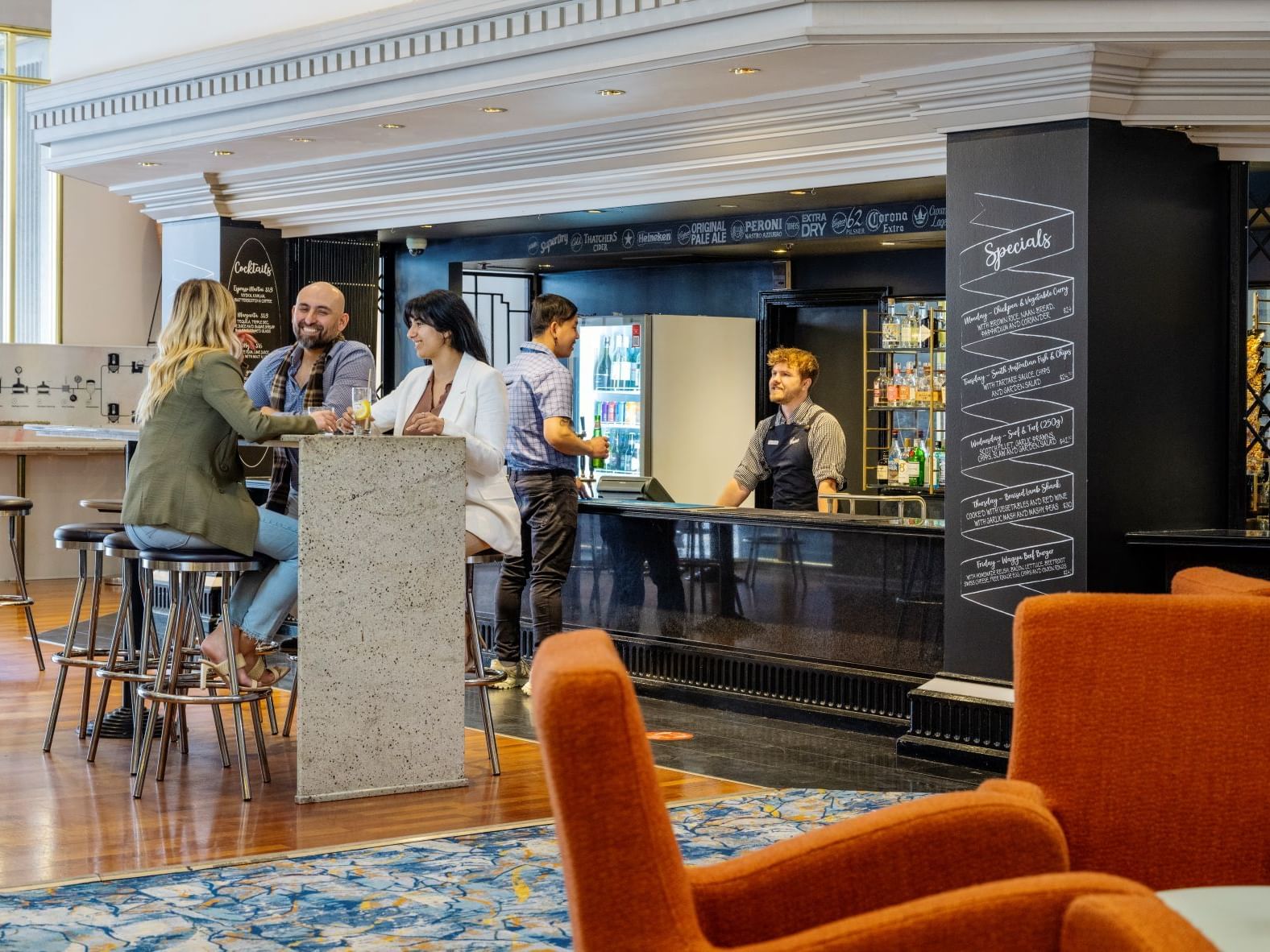 Guests socialising at Sebsatyan's Bar in Hotel Grand Chancellor Adelaide.