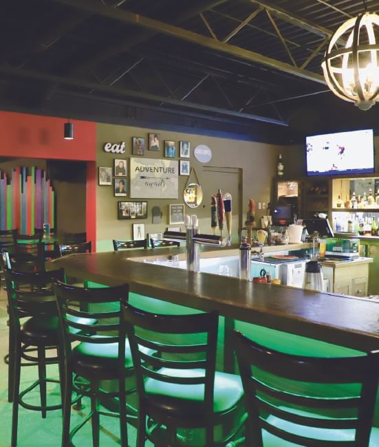 Bar counter & TV in Sipps Bar & Grill at Stanford Inn & Suites