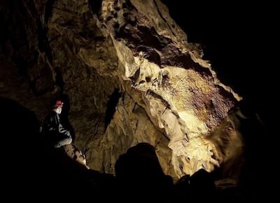 Man exploring the interior of Canmore Caves near Blackstone Mountain Lodge