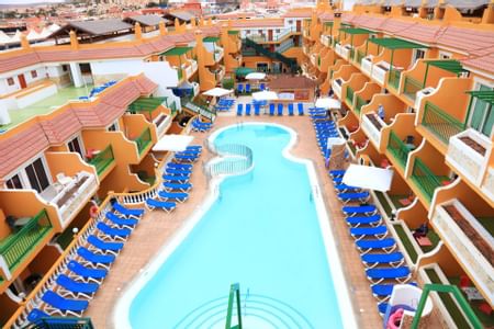 Aerial view of the outdoor pool and lounges at Caleta Garden