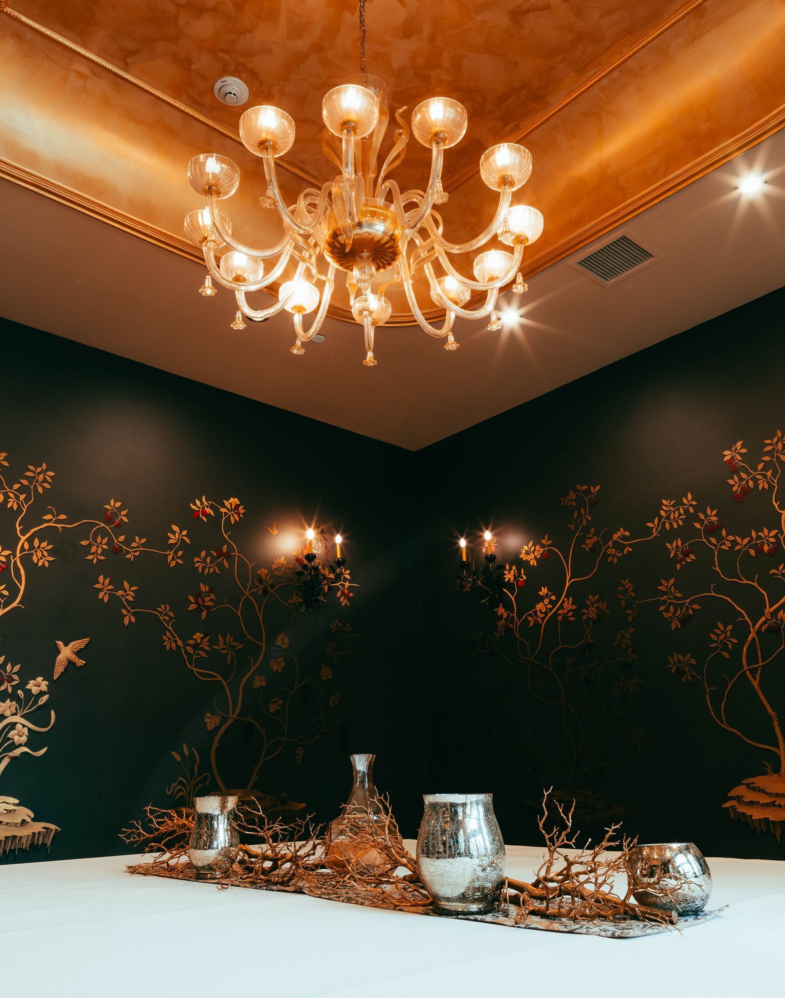 Lorem ipsum Room with chandelier and black wall with floral design