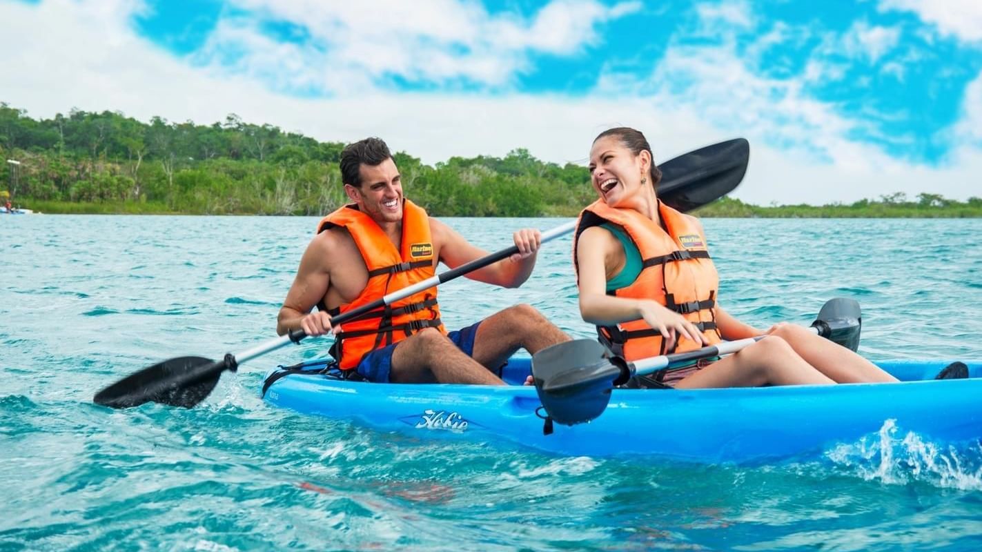 A couple kayaking near Live Aqua Private Residences