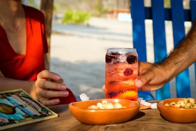 Waiter serving a cocktail at Marea Beachfront Villas