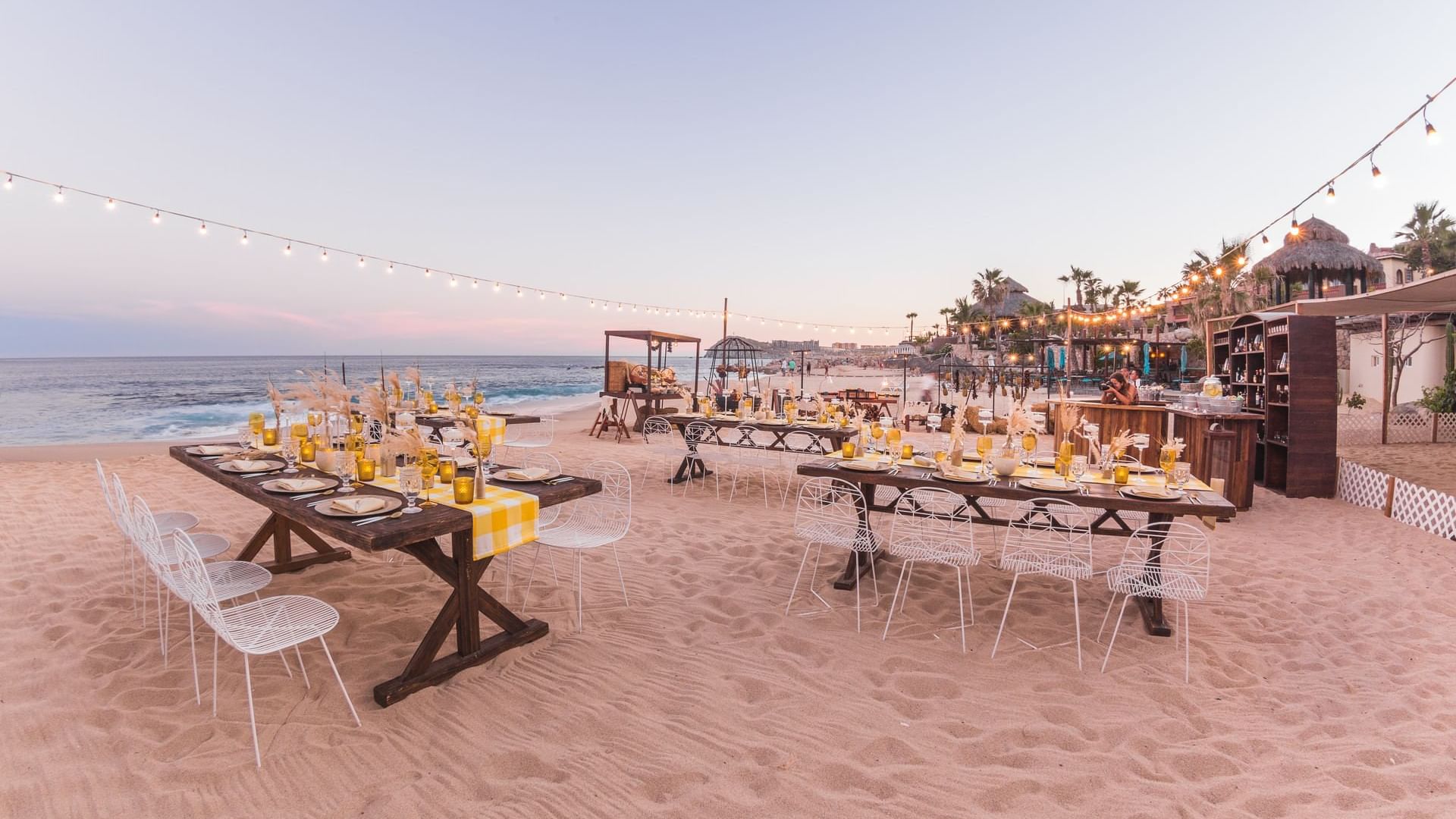 BBQ Dinner arrangements on the beach with chairs and candles at Montage - Hacienda del Mar Los Cabos