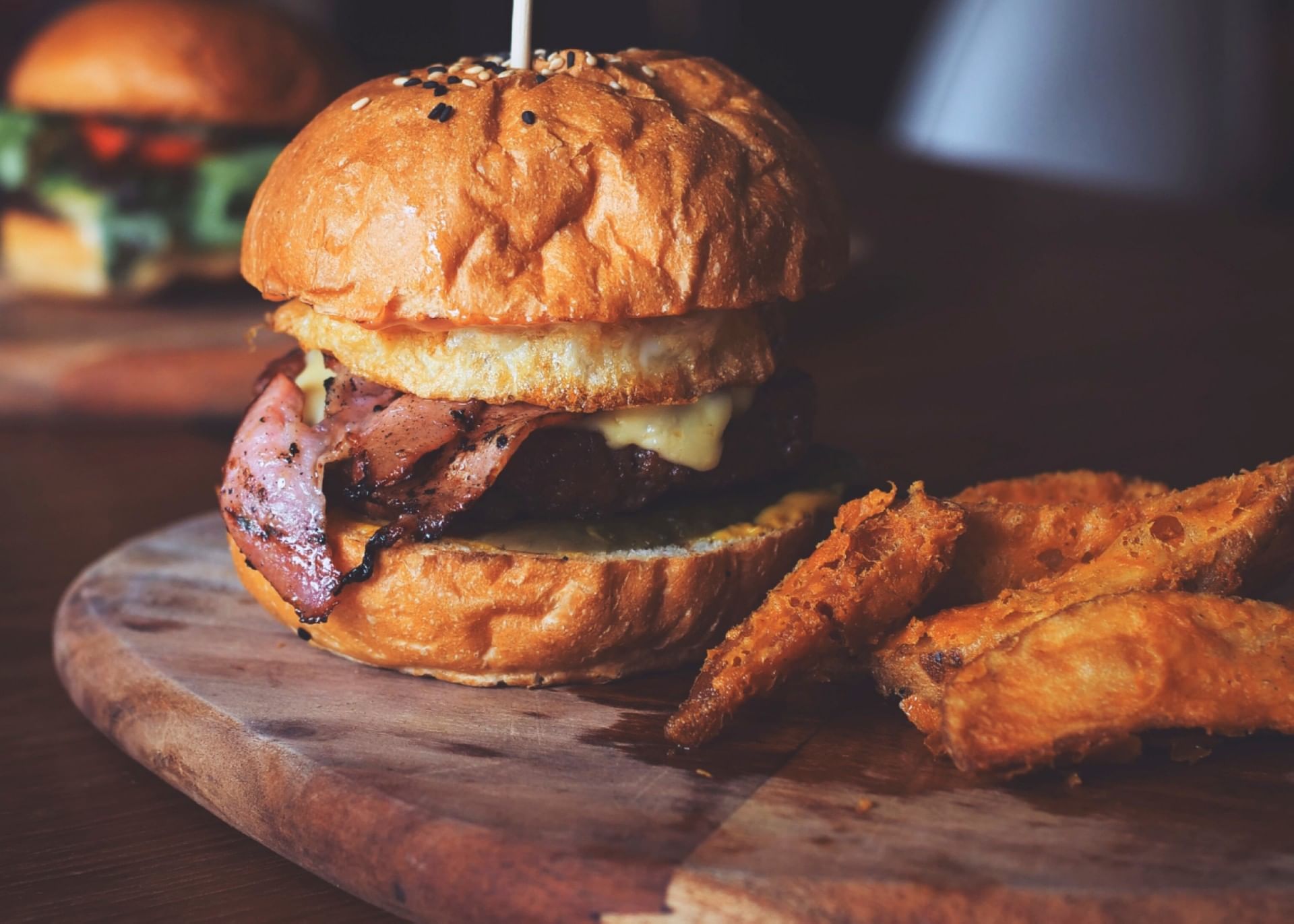 Close-up of burger by a side of crispy chicken wings served at The Bethel Inn