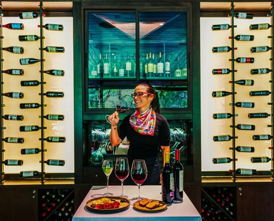 a woman tasting various red and white wines