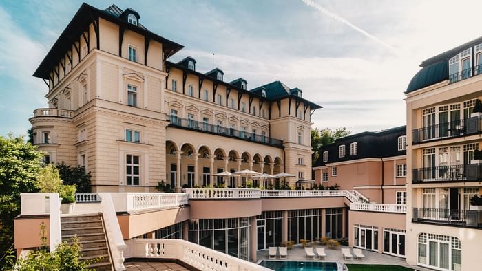 Falkensteiner Spa Resort Marienbad exterior featuring grand architecture with balconies and pool area