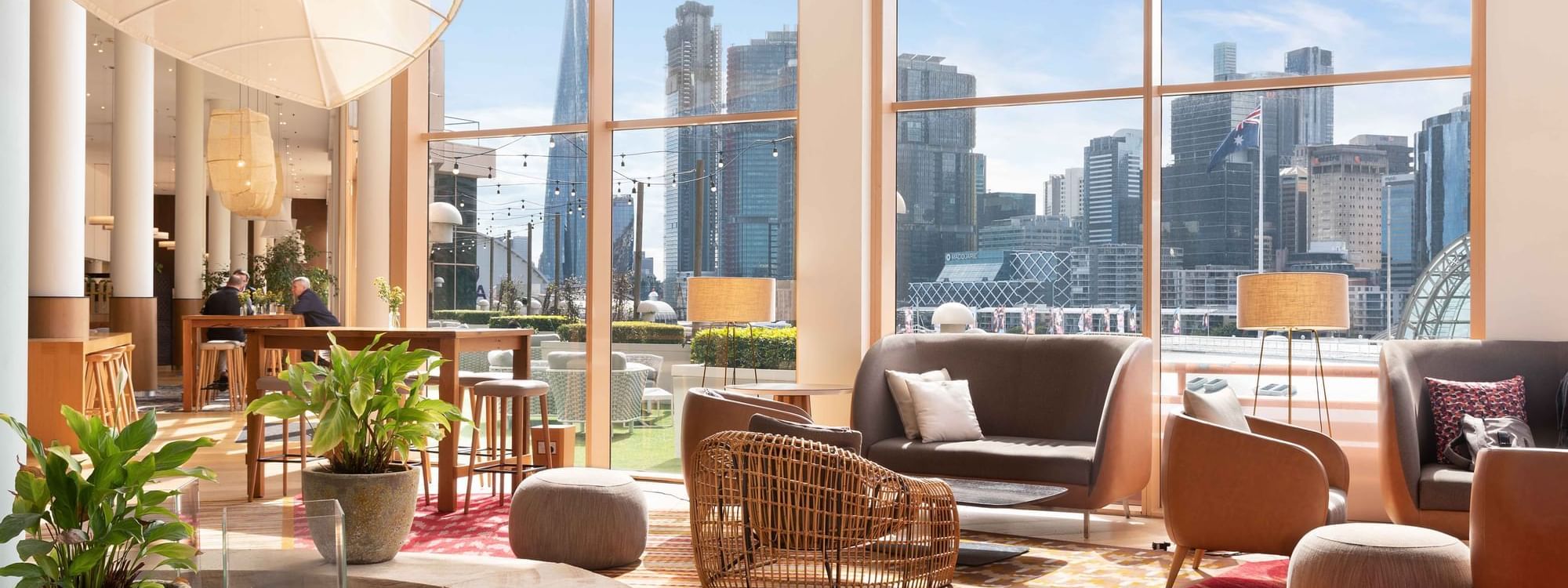 Lobby lounge with city skyline views from large windows at Novotel Sydney on Darling Harbour