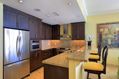 Kitchen with refrigerator in 1 Bedroom Oceanfront Room at Windsong Resort On The Reef